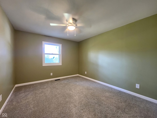 empty room with ceiling fan and carpet floors