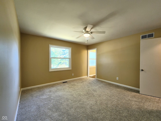 empty room with ceiling fan and carpet floors