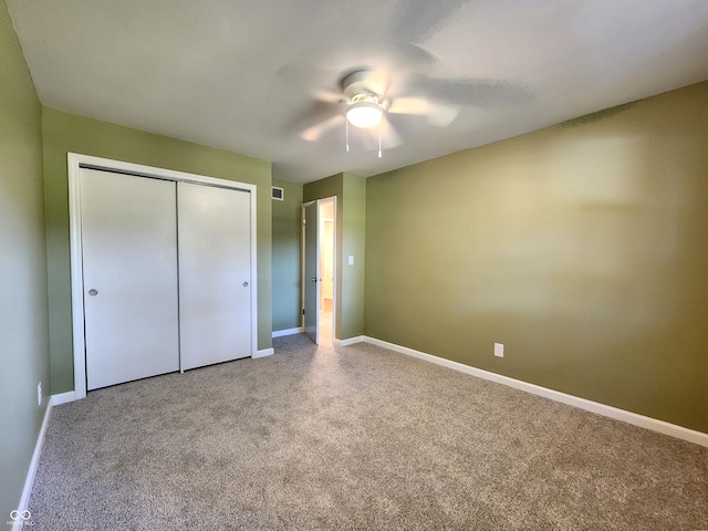 unfurnished bedroom with ceiling fan, a closet, and carpet