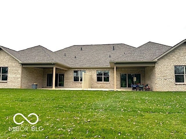 rear view of house with a lawn