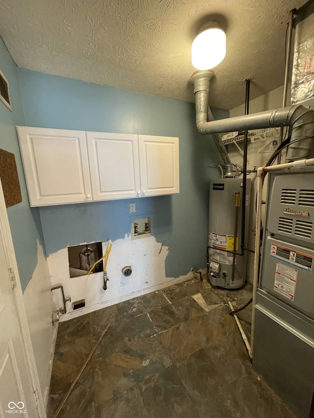 clothes washing area with cabinets, hookup for a washing machine, a textured ceiling, and gas water heater