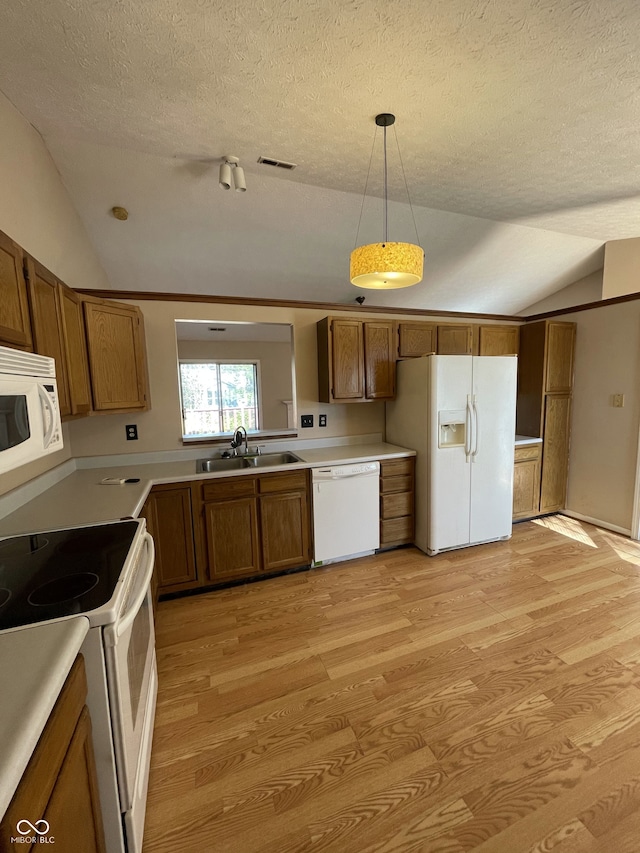 kitchen featuring light hardwood / wood-style flooring, decorative light fixtures, white appliances, and vaulted ceiling