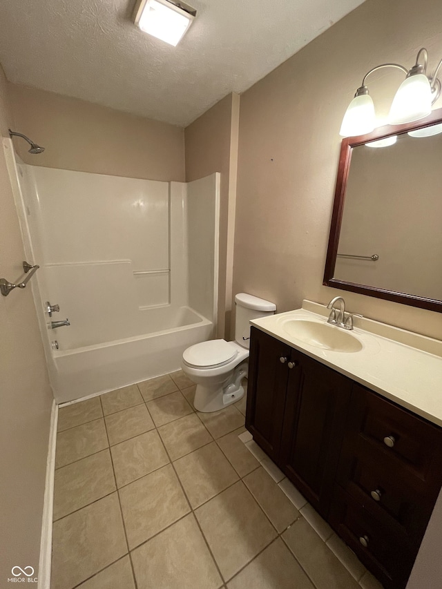 full bathroom with a textured ceiling,  shower combination, vanity, tile patterned floors, and toilet