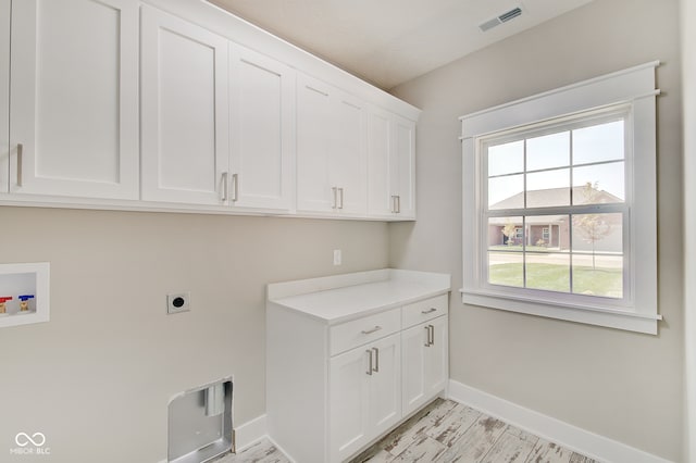 laundry room featuring hookup for a washing machine, cabinets, and hookup for an electric dryer