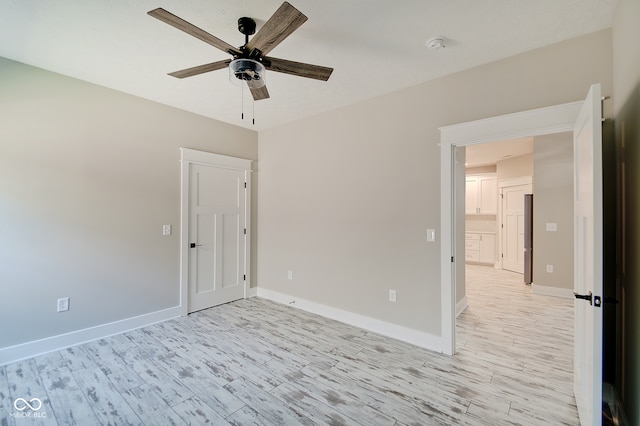 spare room featuring light hardwood / wood-style floors and ceiling fan