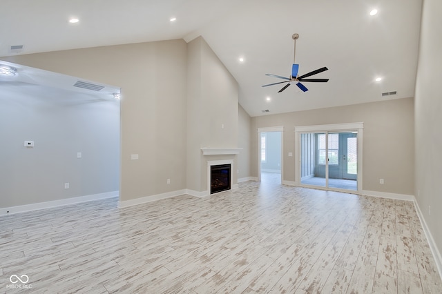 unfurnished living room with light wood-type flooring, ceiling fan, and high vaulted ceiling