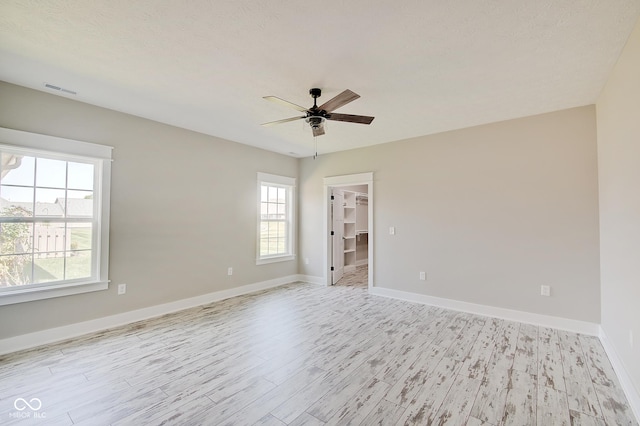 2841 Grandview Ln, Greenwood, IN 46143 - spare room with light wood-style floors, ceiling fan, baseboards, and visible vents