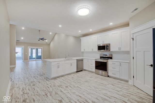 2841 Grandview Ln, Greenwood, IN 46143 - kitchen featuring a sink, light countertops, ceiling fan, appliances with stainless steel finishes, and a peninsula
