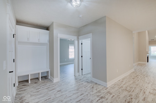 interior space with light wood-type flooring and a textured ceiling