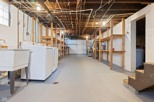 basement featuring washer and dryer and sink