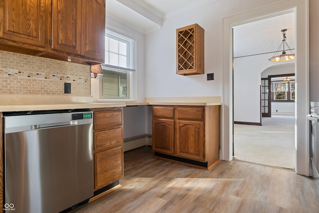 kitchen with backsplash, light hardwood / wood-style flooring, stainless steel dishwasher, ornamental molding, and decorative light fixtures