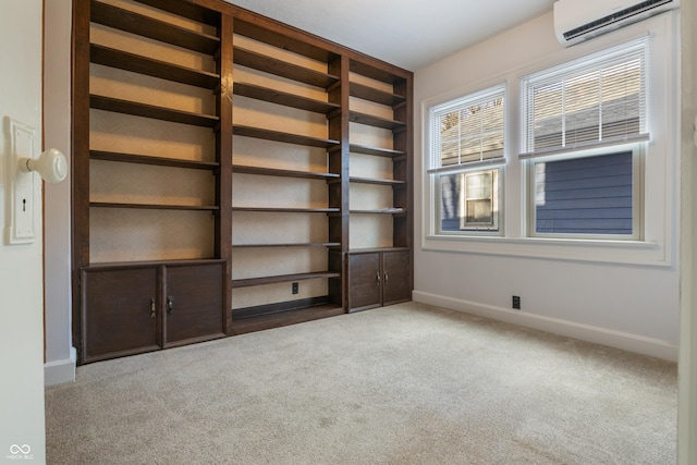 interior space featuring a wall mounted AC and light colored carpet