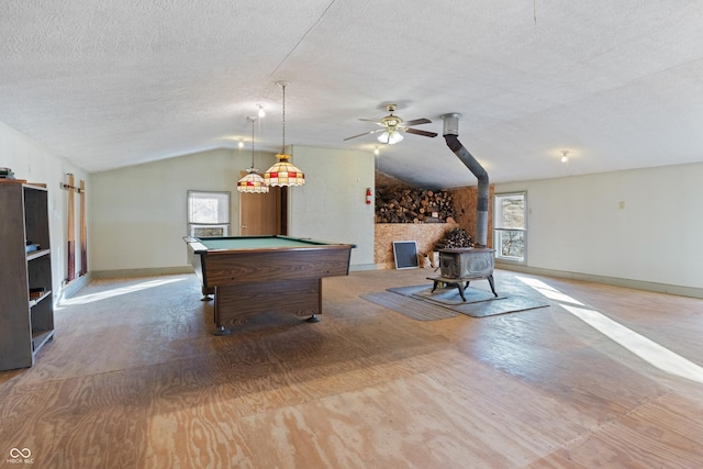 playroom with vaulted ceiling, a wood stove, plenty of natural light, and pool table