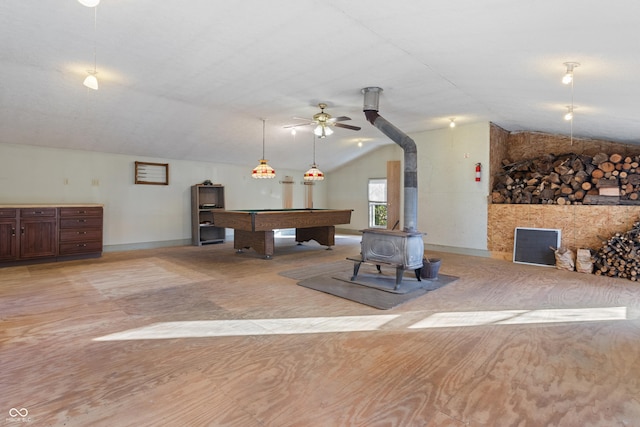 game room featuring a wood stove, ceiling fan, vaulted ceiling, and pool table