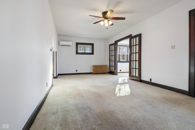 unfurnished room with a wall mounted air conditioner, french doors, light carpet, radiator, and ceiling fan