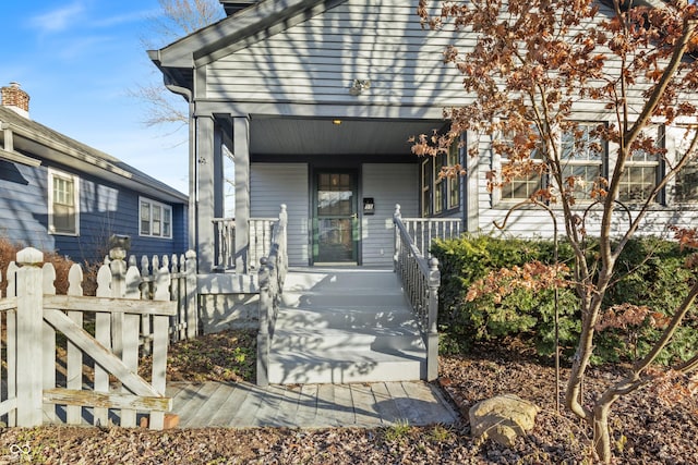 view of exterior entry with a porch