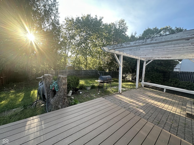 deck with a fenced backyard and a pergola