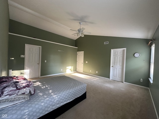 unfurnished bedroom featuring visible vents, baseboards, carpet flooring, and vaulted ceiling