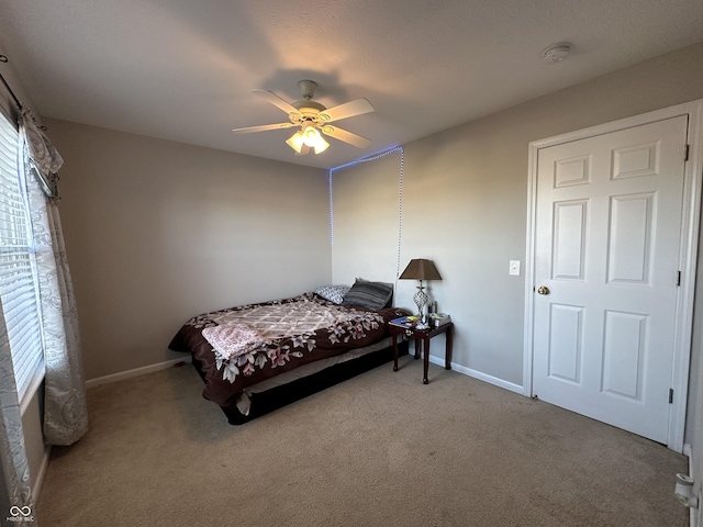 bedroom with baseboards, carpet floors, and a ceiling fan