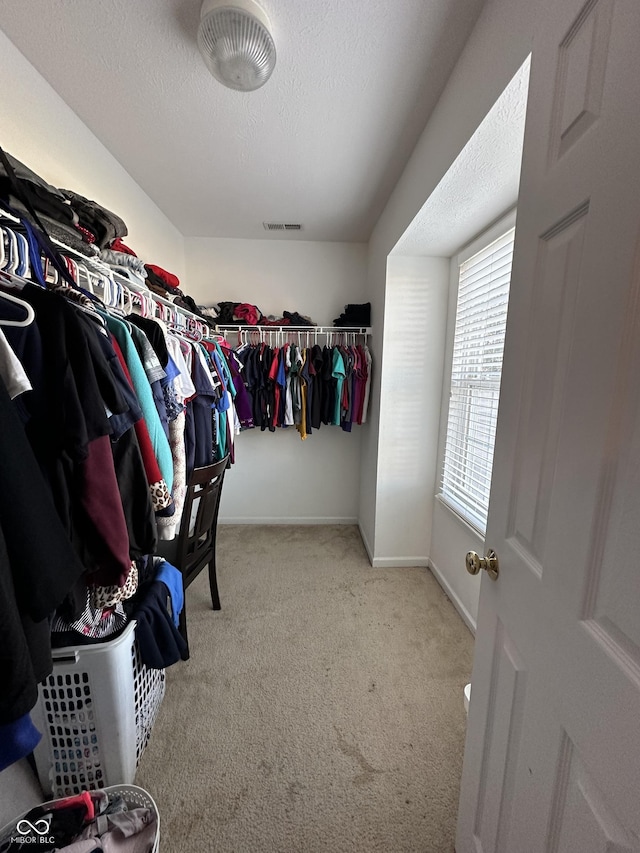 spacious closet with visible vents and carpet