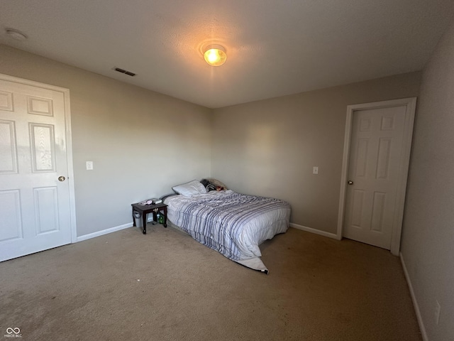 carpeted bedroom with baseboards and visible vents