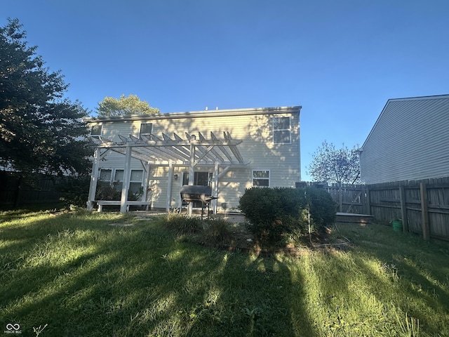 back of house with a patio, a yard, a fenced backyard, and a pergola