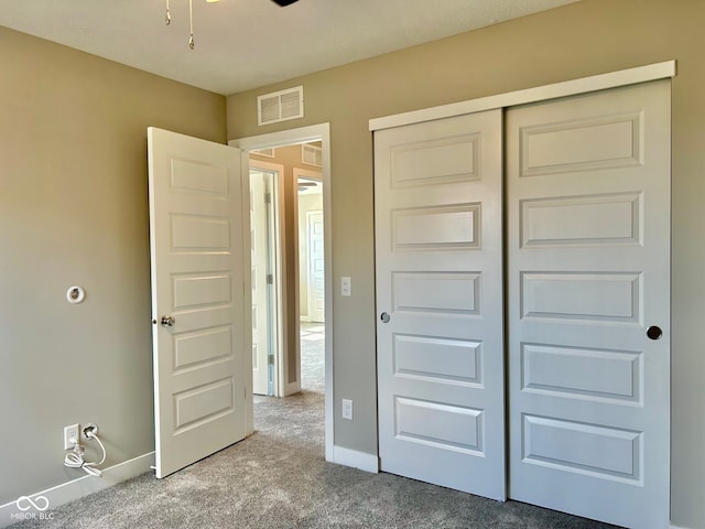 unfurnished bedroom featuring a closet and carpet flooring