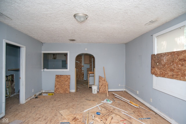 interior space with a textured ceiling