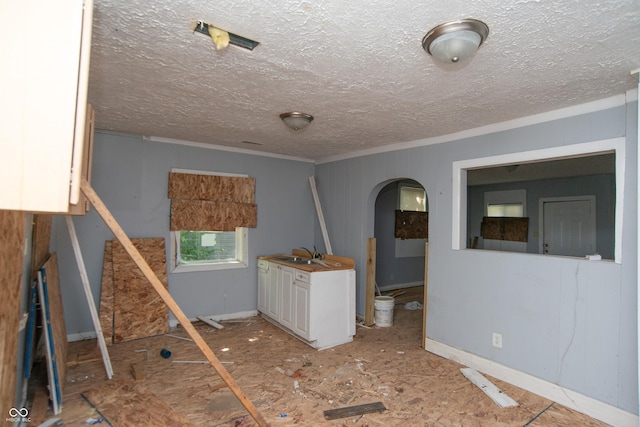 2363 N Gale St, Indianapolis, IN 46218 - unfurnished room with ornamental molding, arched walkways, a sink, and a textured ceiling