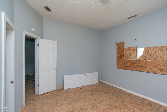 spare room featuring a textured ceiling