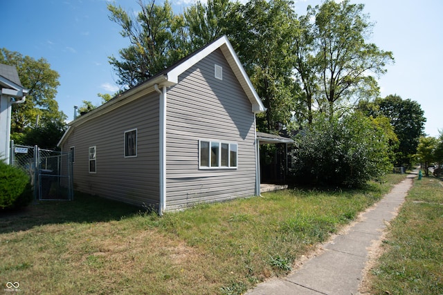 2363 N Gale St, Indianapolis, IN 46218 - view of side of property featuring a lawn and a gate