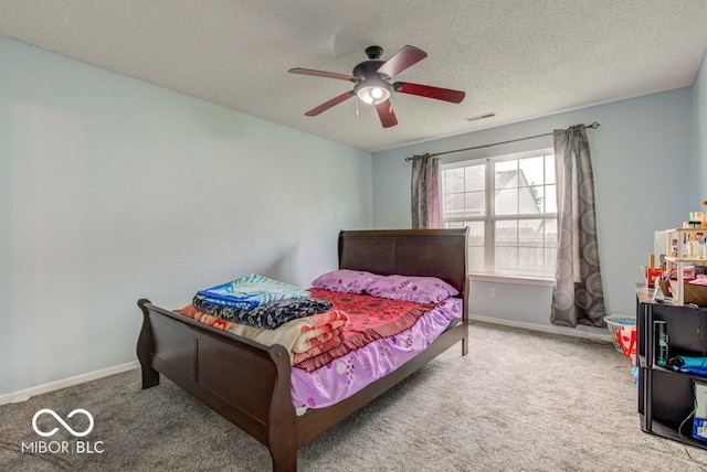 bedroom featuring a textured ceiling, carpet floors, and ceiling fan