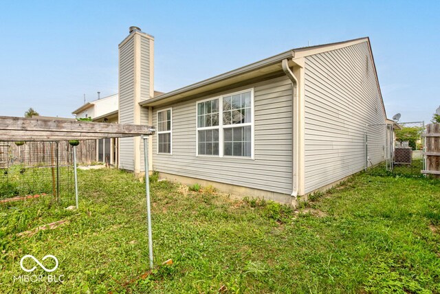 rear view of house with a yard