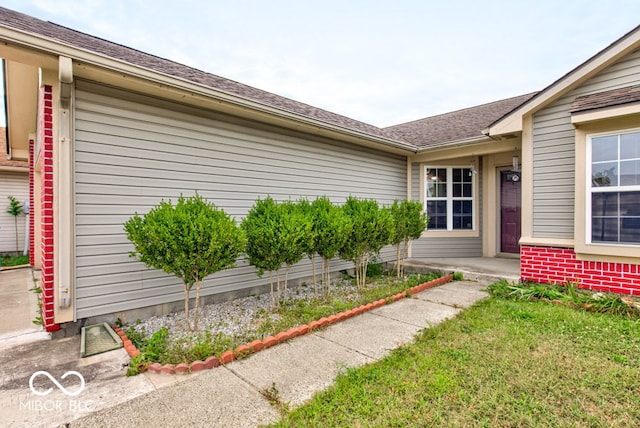 entrance to property with a lawn