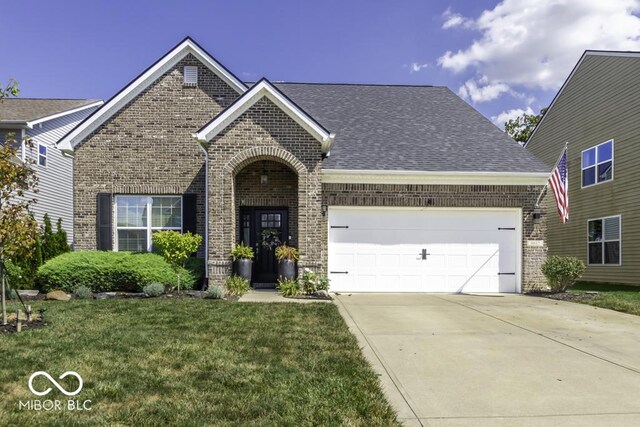 view of front of home featuring a garage and a front yard