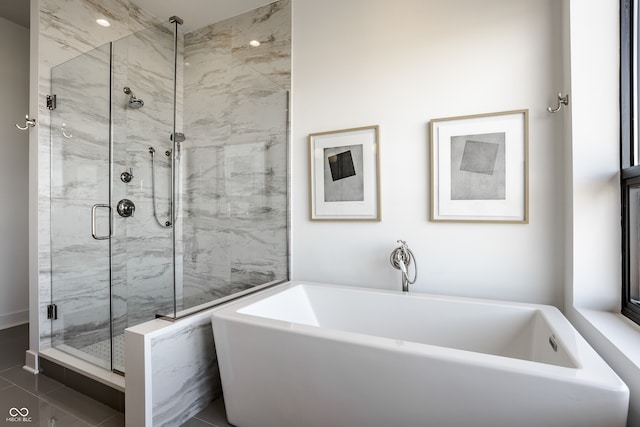 bathroom with tile patterned floors and shower with separate bathtub