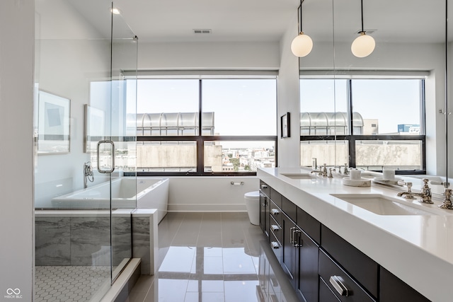 full bathroom featuring a healthy amount of sunlight, separate shower and tub, vanity, and tile patterned floors