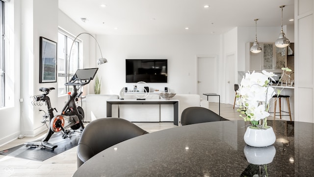 interior space featuring pendant lighting, dark stone counters, and light hardwood / wood-style floors