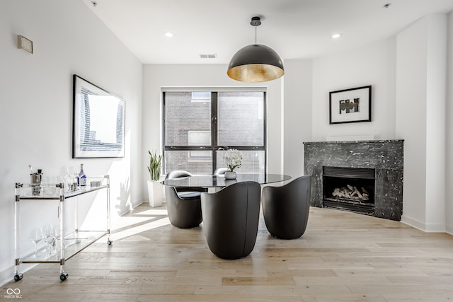 interior space featuring light hardwood / wood-style floors and a high end fireplace