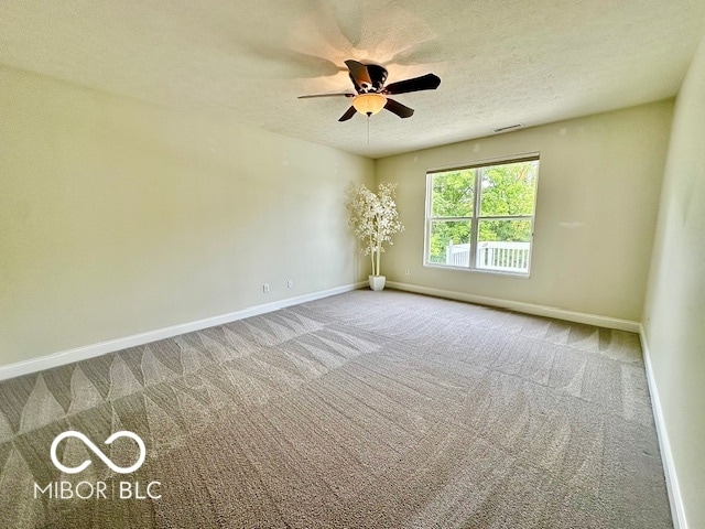 empty room with a textured ceiling, ceiling fan, and carpet floors