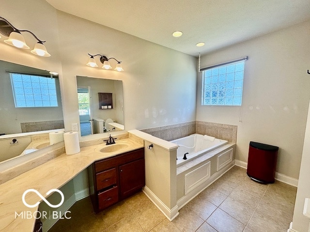 bathroom featuring vanity, a tub, and tile patterned flooring