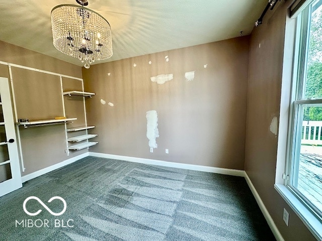 unfurnished dining area featuring an inviting chandelier and carpet floors