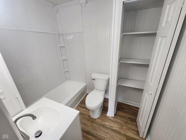 bathroom featuring vanity, toilet, wood-type flooring, and a bathtub