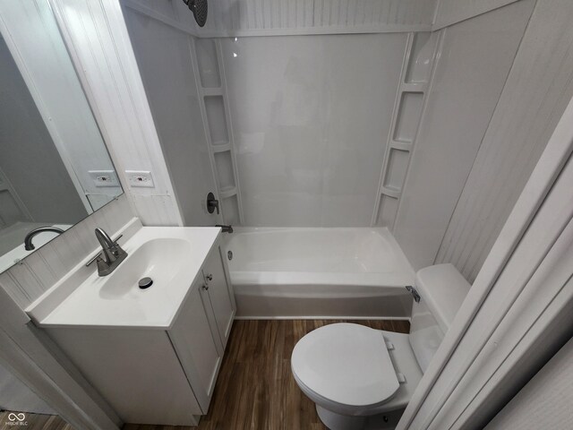 full bathroom with vanity, toilet, hardwood / wood-style flooring, and shower / bath combination