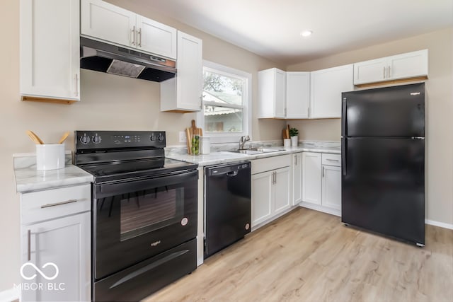 kitchen with light wood-type flooring, black appliances, sink, and white cabinets