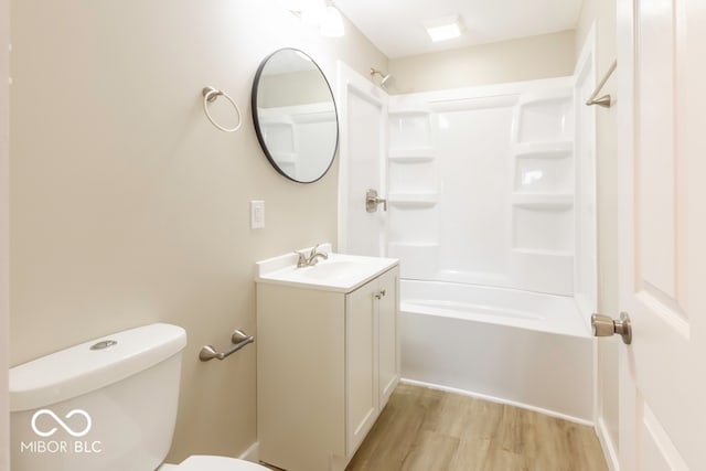 full bathroom with bathtub / shower combination, wood-type flooring, toilet, and vanity