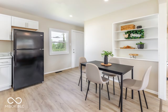 dining space featuring light hardwood / wood-style flooring