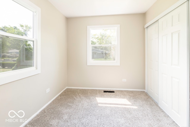 unfurnished bedroom featuring carpet and a closet