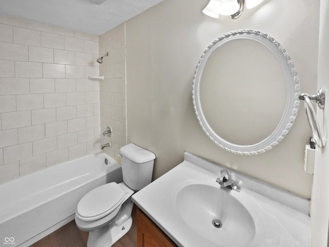 full bathroom with tiled shower / bath combo, vanity, and toilet