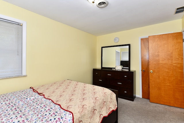 bedroom featuring light colored carpet